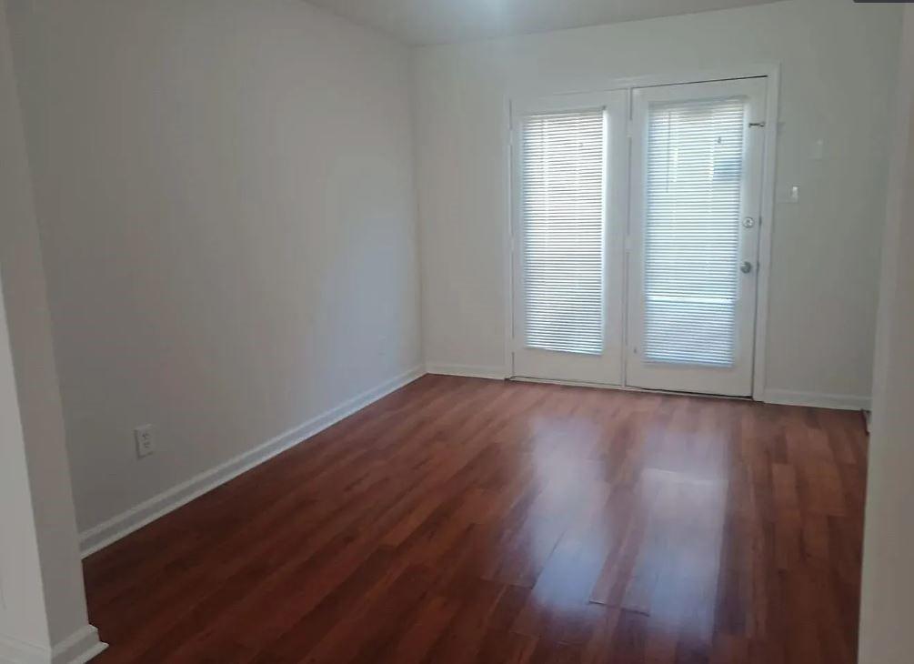 110 Holcomb Ferry Road Roswell, GA 30076 - Photo 11 of 14 an empty room with wooden floor and windows