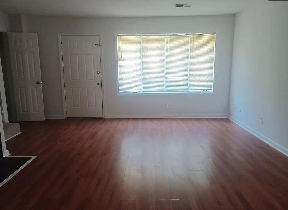 110 Holcomb Ferry Road Roswell, GA 30076 - Photo 8 of 14 an empty room with wooden floor and windows