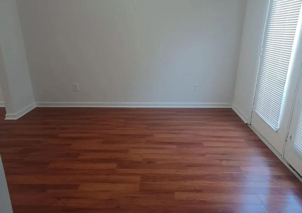 110 Holcomb Ferry Road Roswell, GA 30076 - Photo 9 of 14 an empty room with wooden floor and windows
