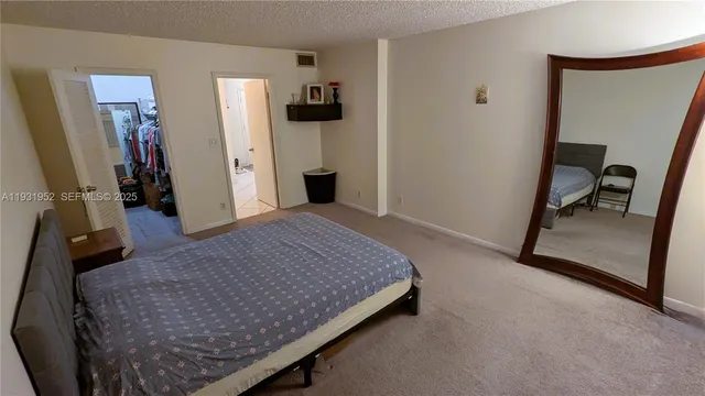 a bed room with a bed and a chair