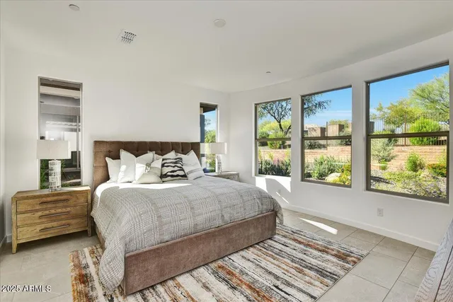 a bedroom with a bed and a large window