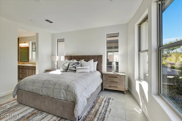 a bedroom with a bed and a large window