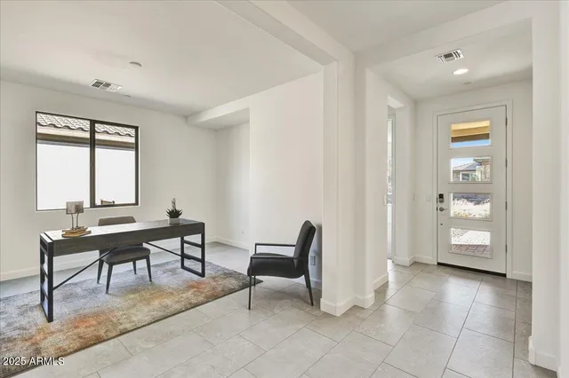 a view of a livingroom with furniture and a window