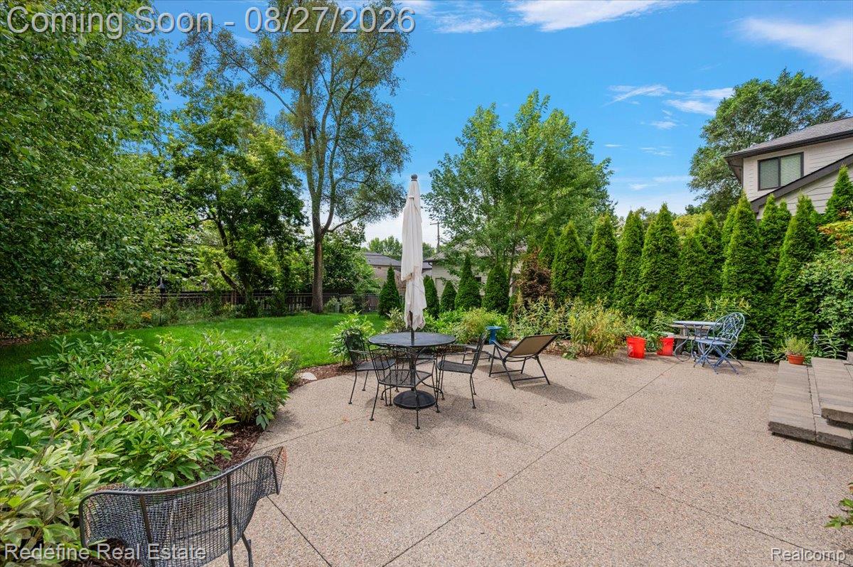 149 Woodward Avenue Rochester, MI 48307 - Photo 38 of 51 Expansive patio with mature landscaping, manicured lawn, and privacy hedging