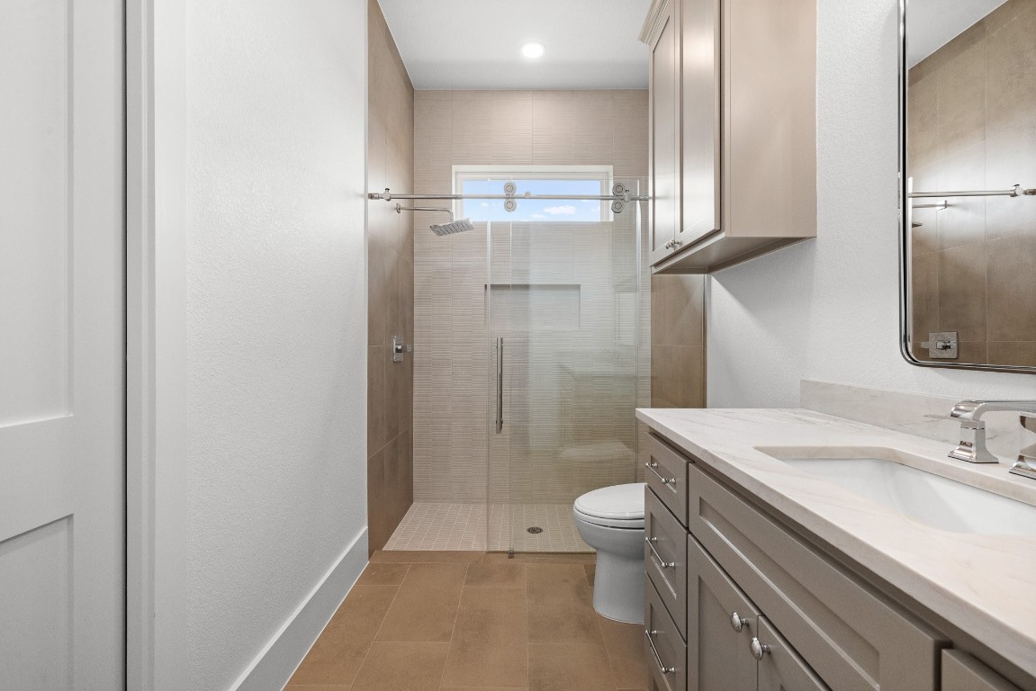 424 Pleasant Hill School Road Brenham, TX 77833 - Photo 14 of 26 a bathroom with a sink toilet and shower