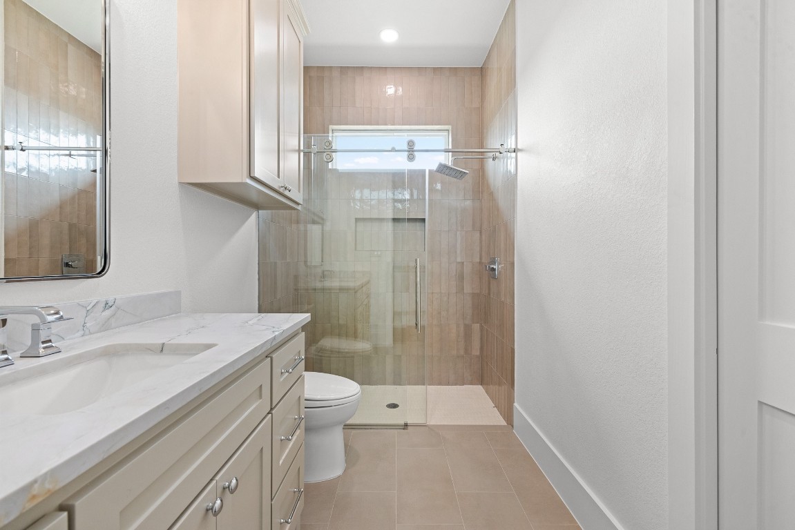 424 Pleasant Hill School Road Brenham, TX 77833 - Photo 18 of 26 a bathroom with a sink a toilet and shower