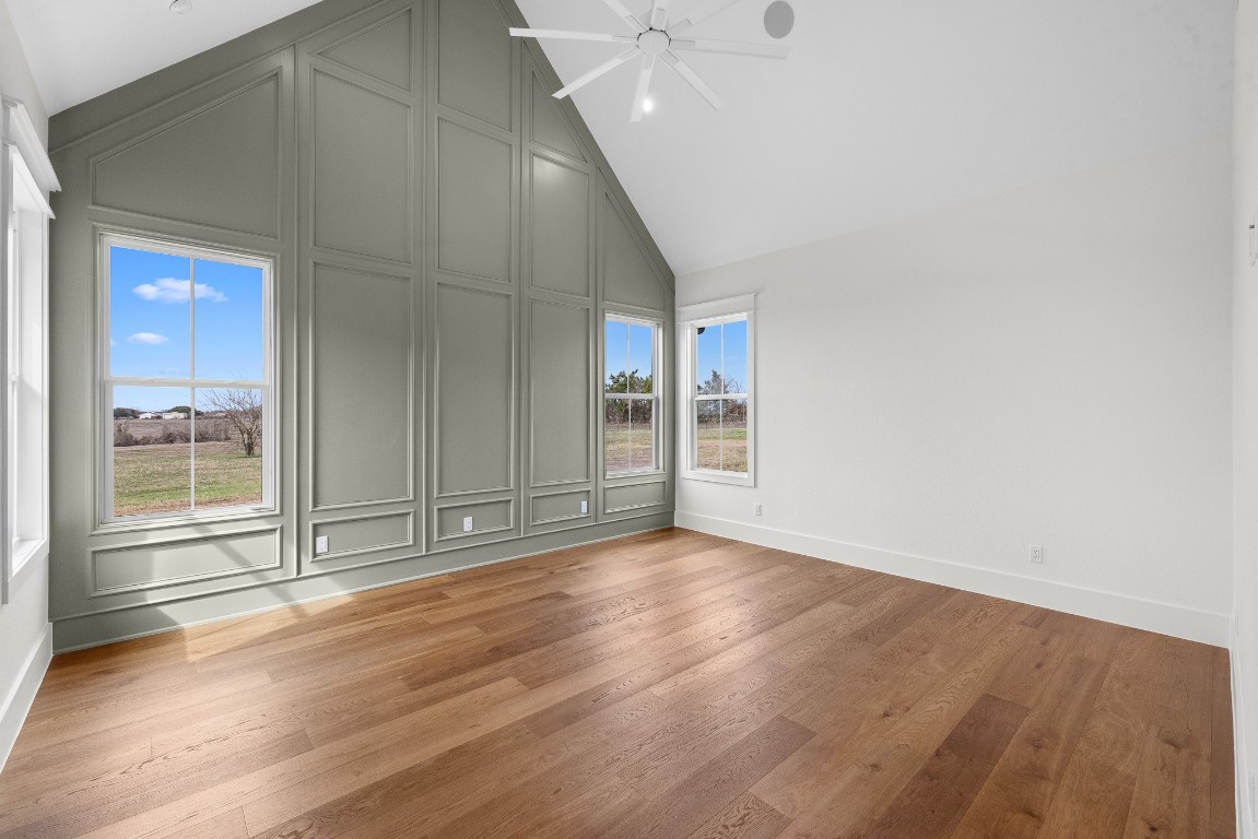 424 Pleasant Hill School Road Brenham, TX 77833 - Photo 9 of 26 an empty room with wooden floor and windows