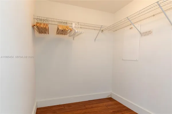 a view of walk in closet with empty racks