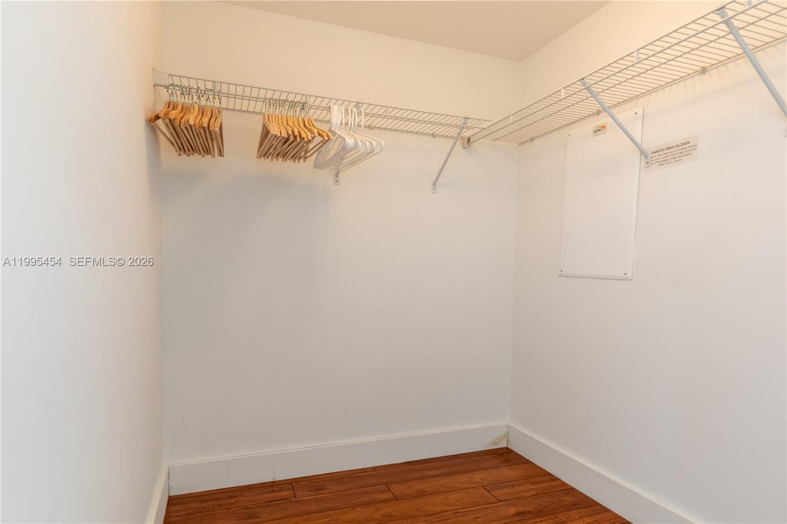 90 Southwest 3rd Street, Unit 3806 Miami, FL 33130 - Photo 12 of 32 a view of walk in closet with empty racks