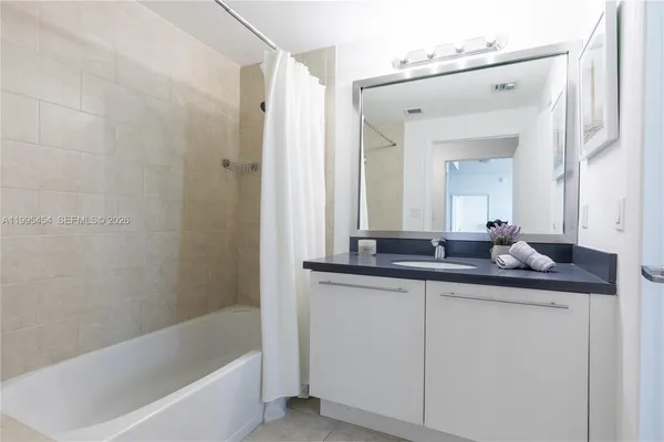 a bath room with a sink and a mirror