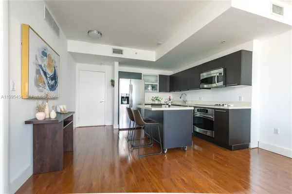 a kitchen with a sink cabinets and wooden floor