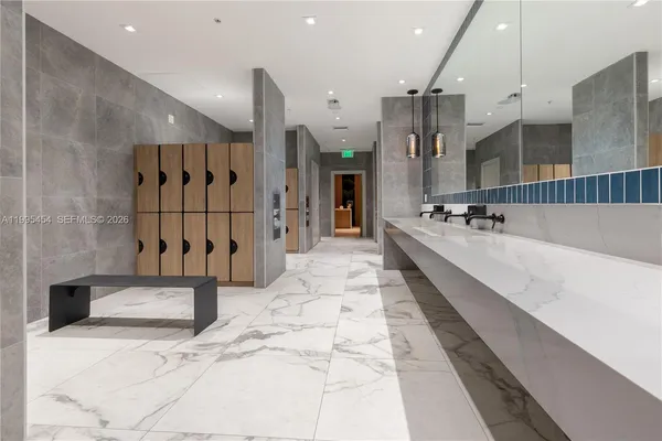 a large hall with stainless steel appliances kitchen island granite countertop furniture and a fireplace