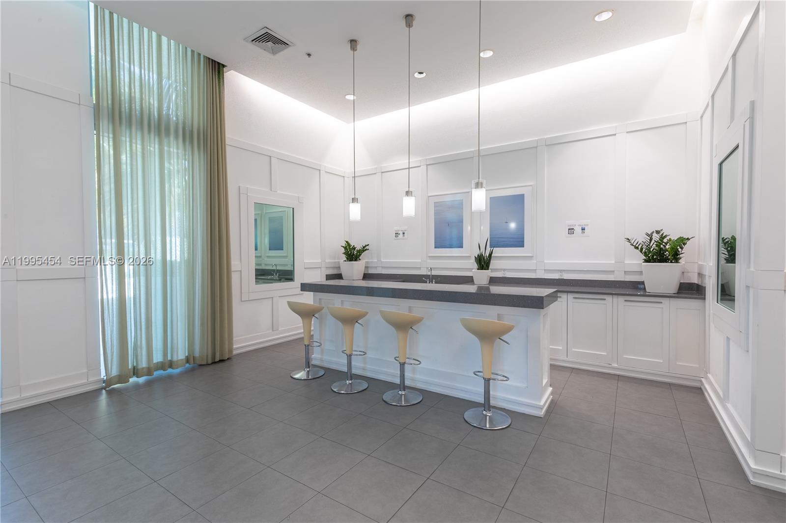 90 Southwest 3rd Street, Unit 3806 Miami, FL 33130 - Photo 29 of 32 a kitchen with kitchen island a sink and counter space