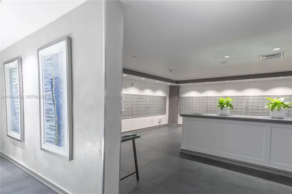 a living room with hardwood floor and a large window