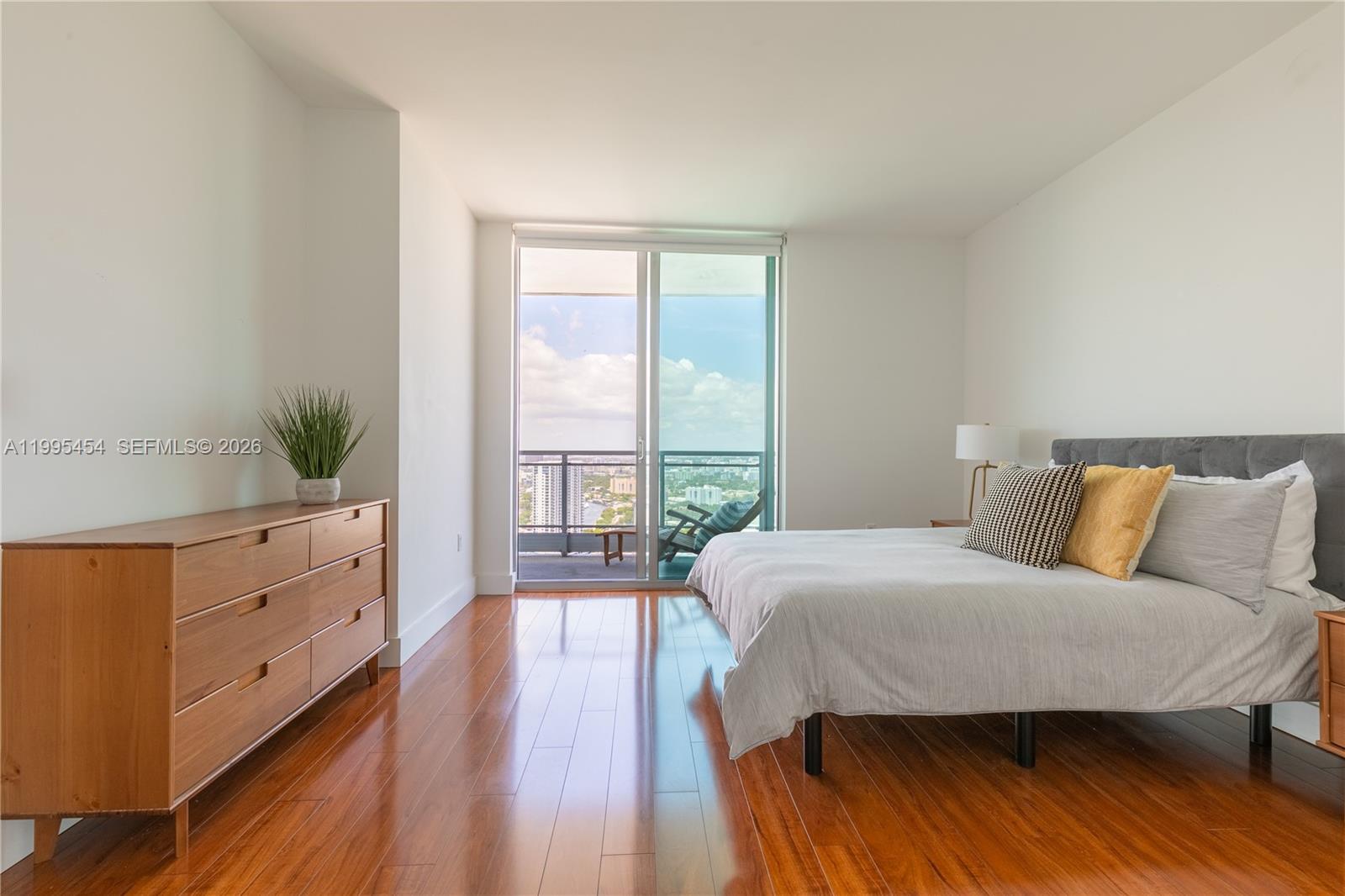 90 Southwest 3rd Street, Unit 3806 Miami, FL 33130 - Photo 8 of 32 a bedroom with a bed and a large window