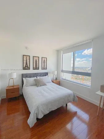 a bedroom with a large bed and a window