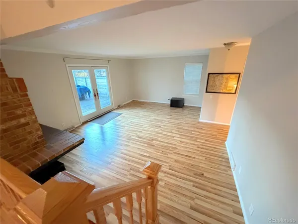 a view of a living room with furniture and wooden floor