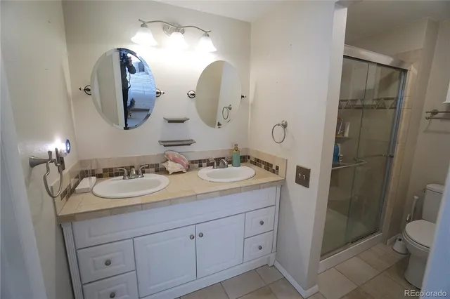 a bathroom with 2 sink and a mirror