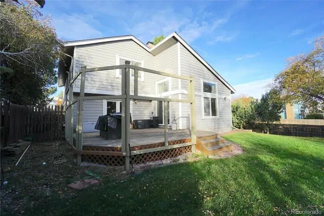 a view of a house with a yard and sitting area