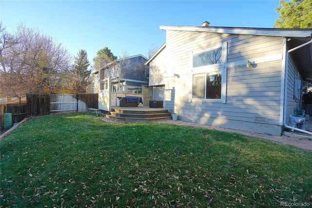 a view of a house with backyard and sitting area