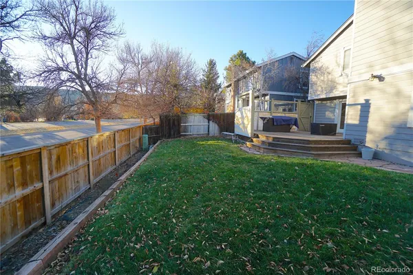 a view of a garden with wooden fence