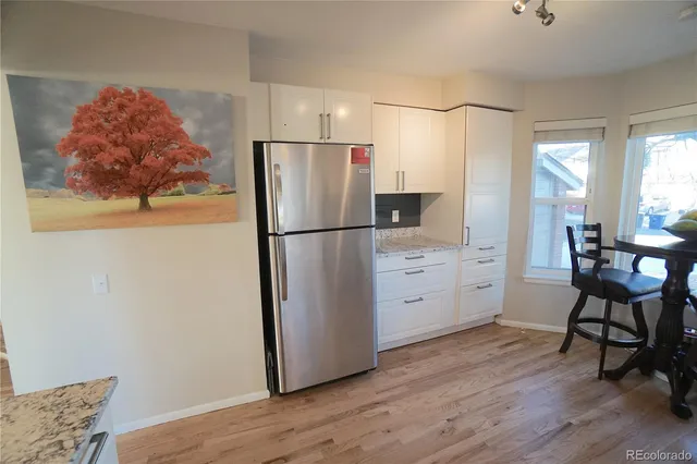 a kitchen with stainless steel appliances a refrigerator and a stove top oven