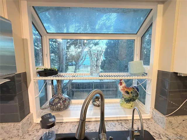 a view of roof deck with table and chairs
