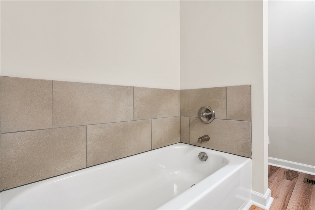 131 Lockaby Road Pelzer, SC 29669 - Photo 28 of 50 This clean and inviting bathroom features a simple bathtub with tiled walls.