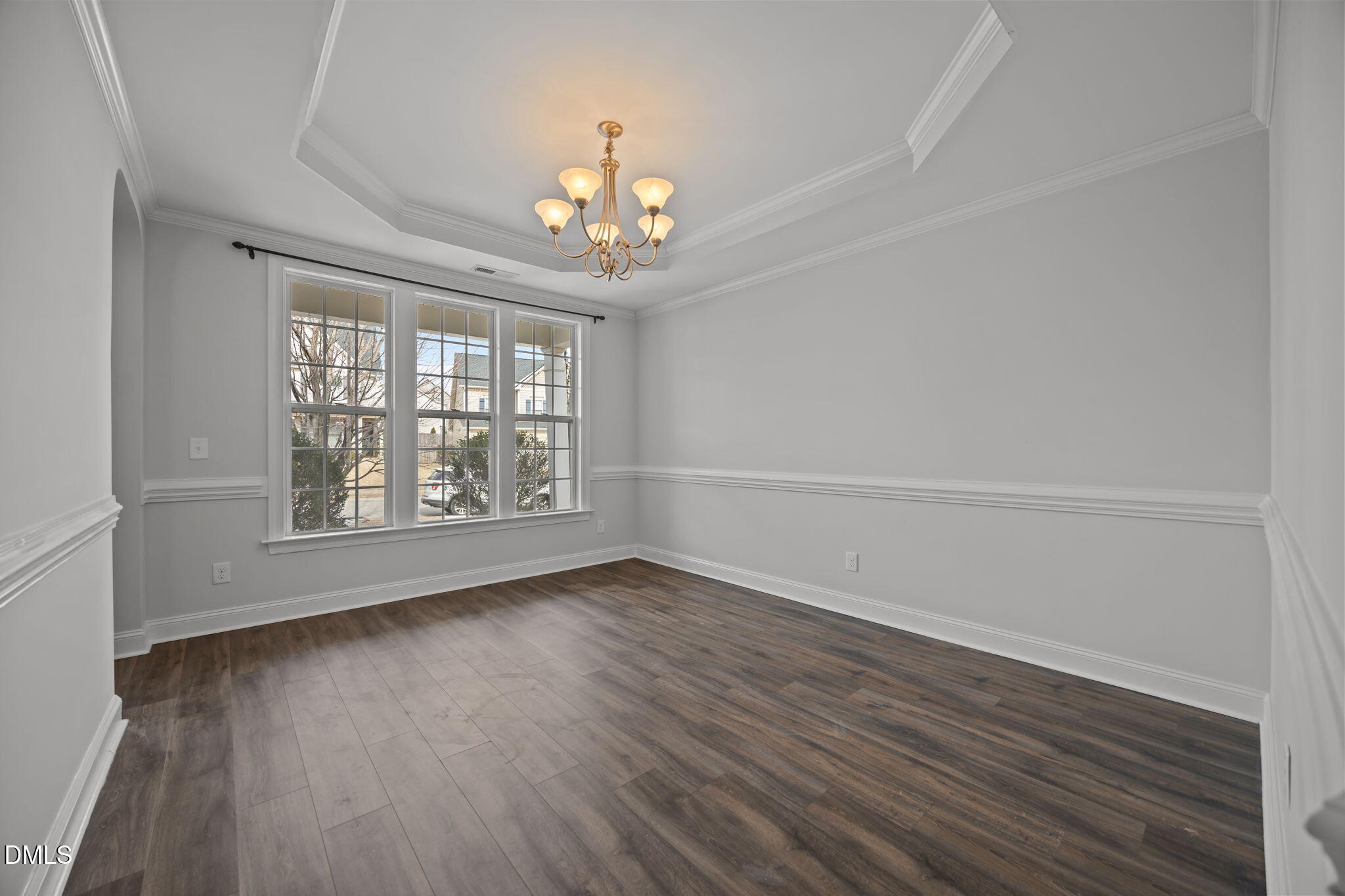 824 Lone Pine Loop Fuquay-Varina, NC 27526 - Photo 10 of 62 an empty room with wooden floor chandelier and windows