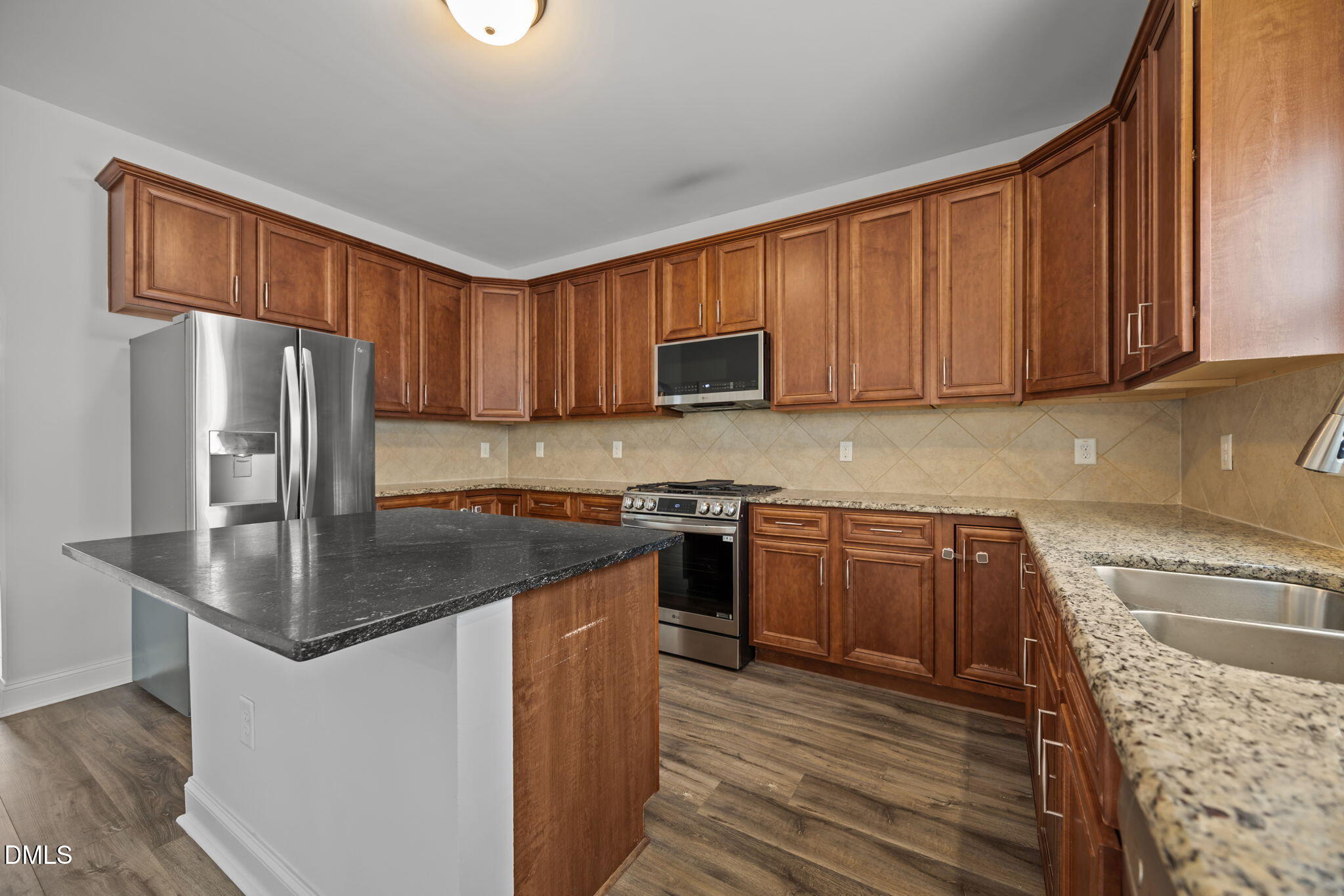824 Lone Pine Loop Fuquay-Varina, NC 27526 - Photo 13 of 62 a kitchen with stainless steel appliances granite countertop a sink stove and refrigerator