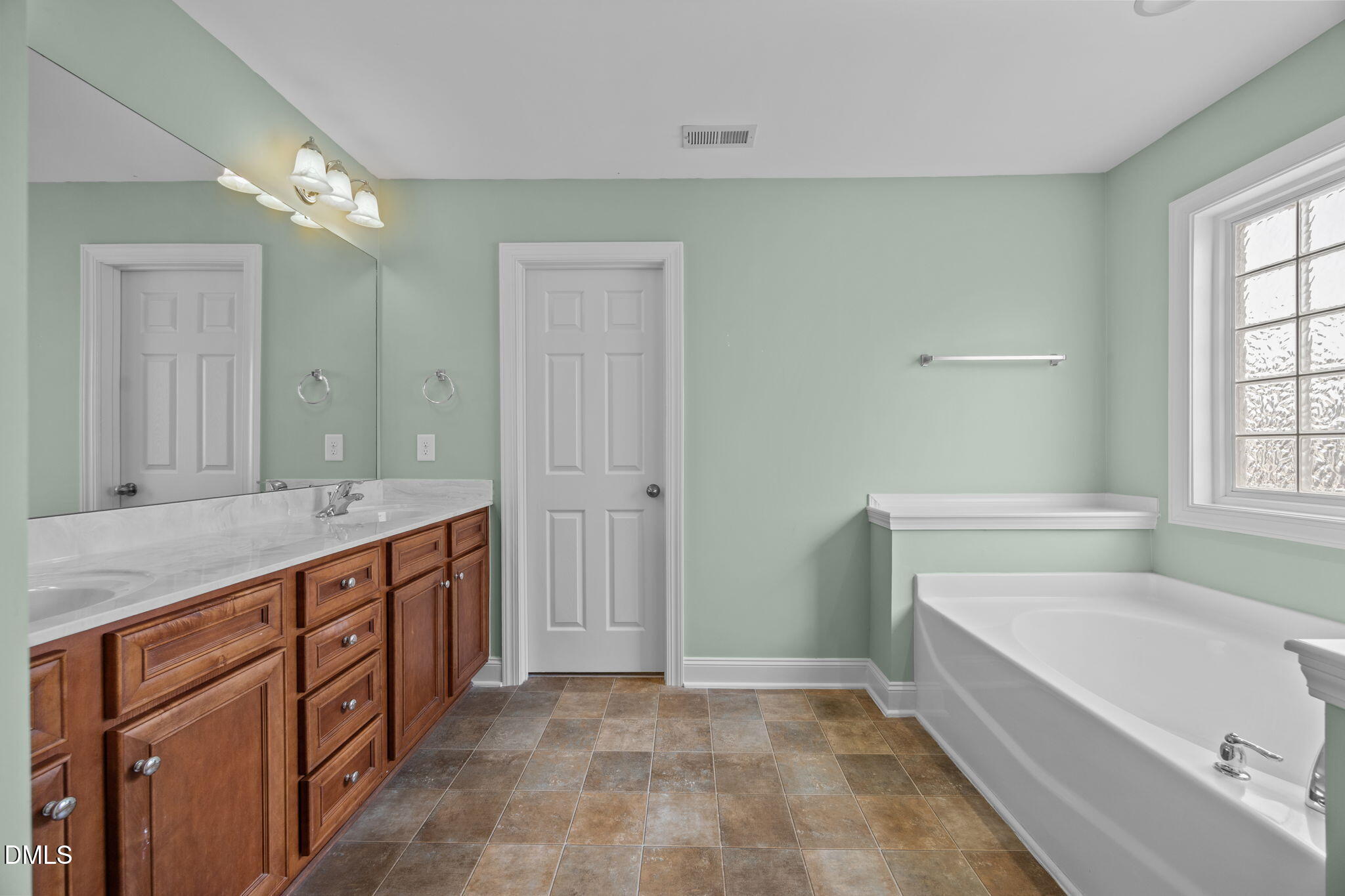 824 Lone Pine Loop Fuquay-Varina, NC 27526 - Photo 32 of 62 a bathroom with a granite countertop double vanity sink a mirror and a bathtub