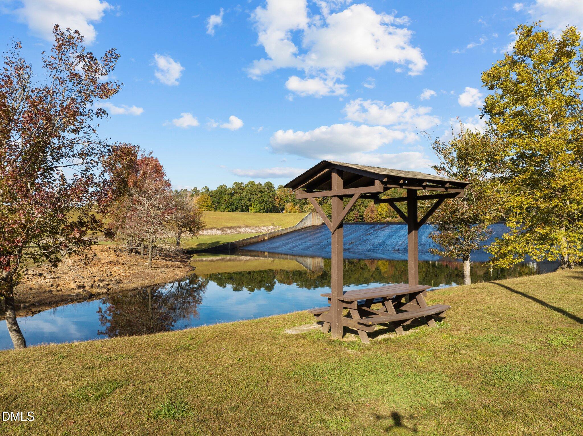 105 Kansas Drive Spring Hope, NC 27882 - Photo 24 of 54 a view of a swimming pool with a bench and lawn chairs