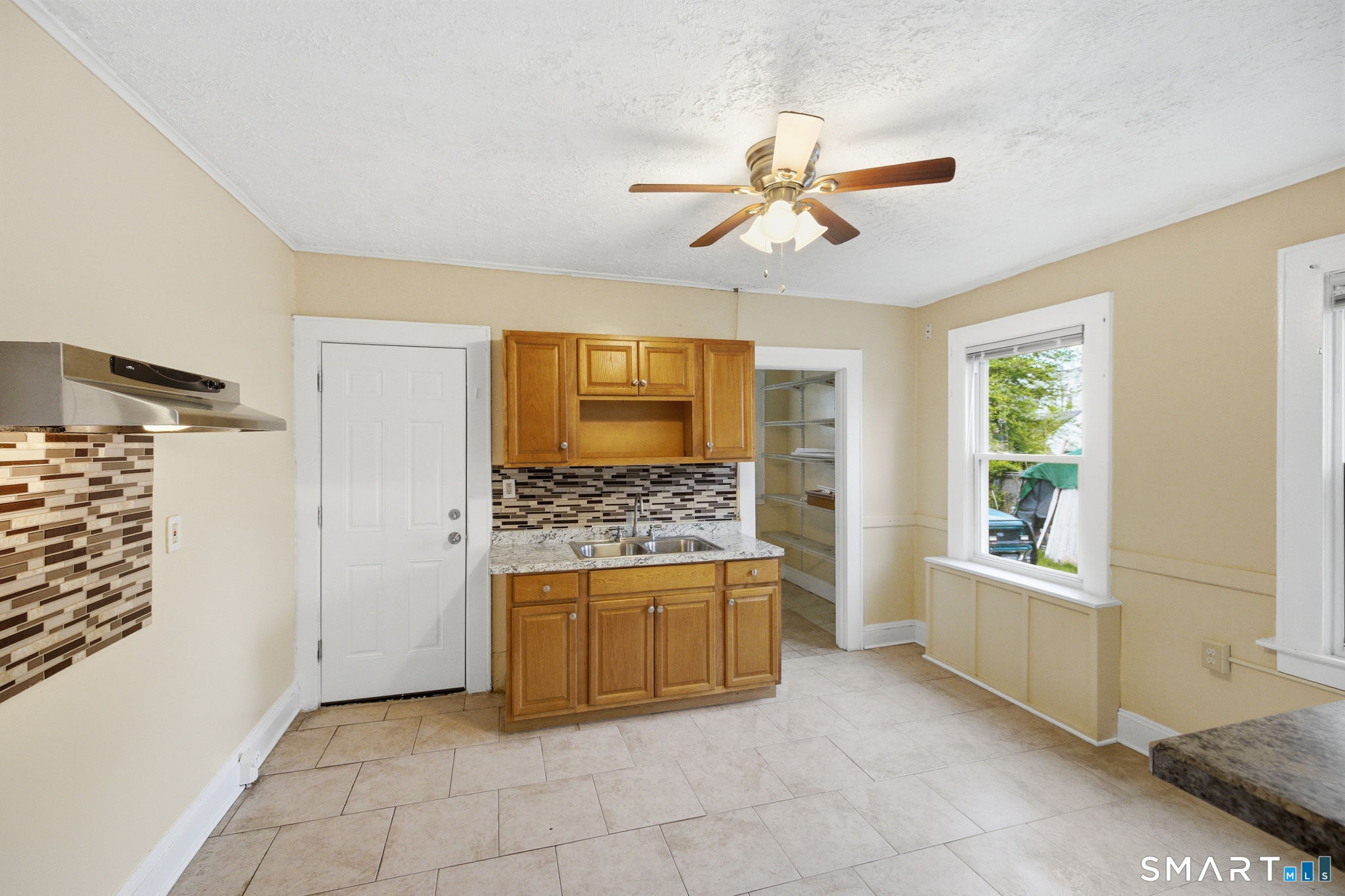 76 Harold Street Hartford, CT 06112 - Photo 7 of 12 a kitchen with stainless steel appliances a stove and a refrigerator