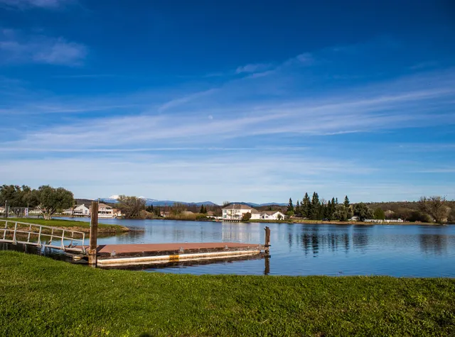 a view of a lake with houses in the back