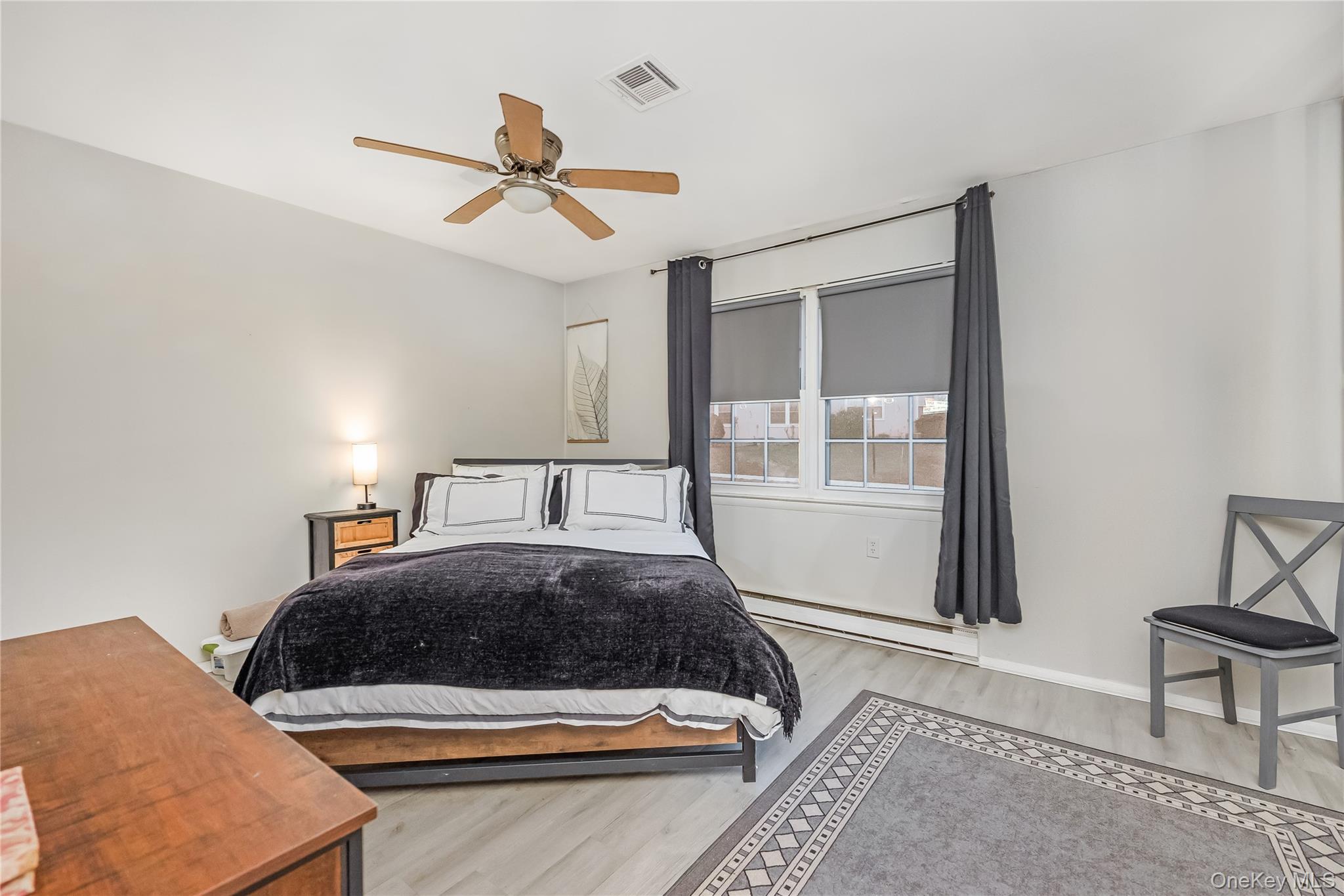 406 Woodbridge Drive, Unit B Ridge, NY 11961 - Photo 14 of 15 a bedroom with a bed and window