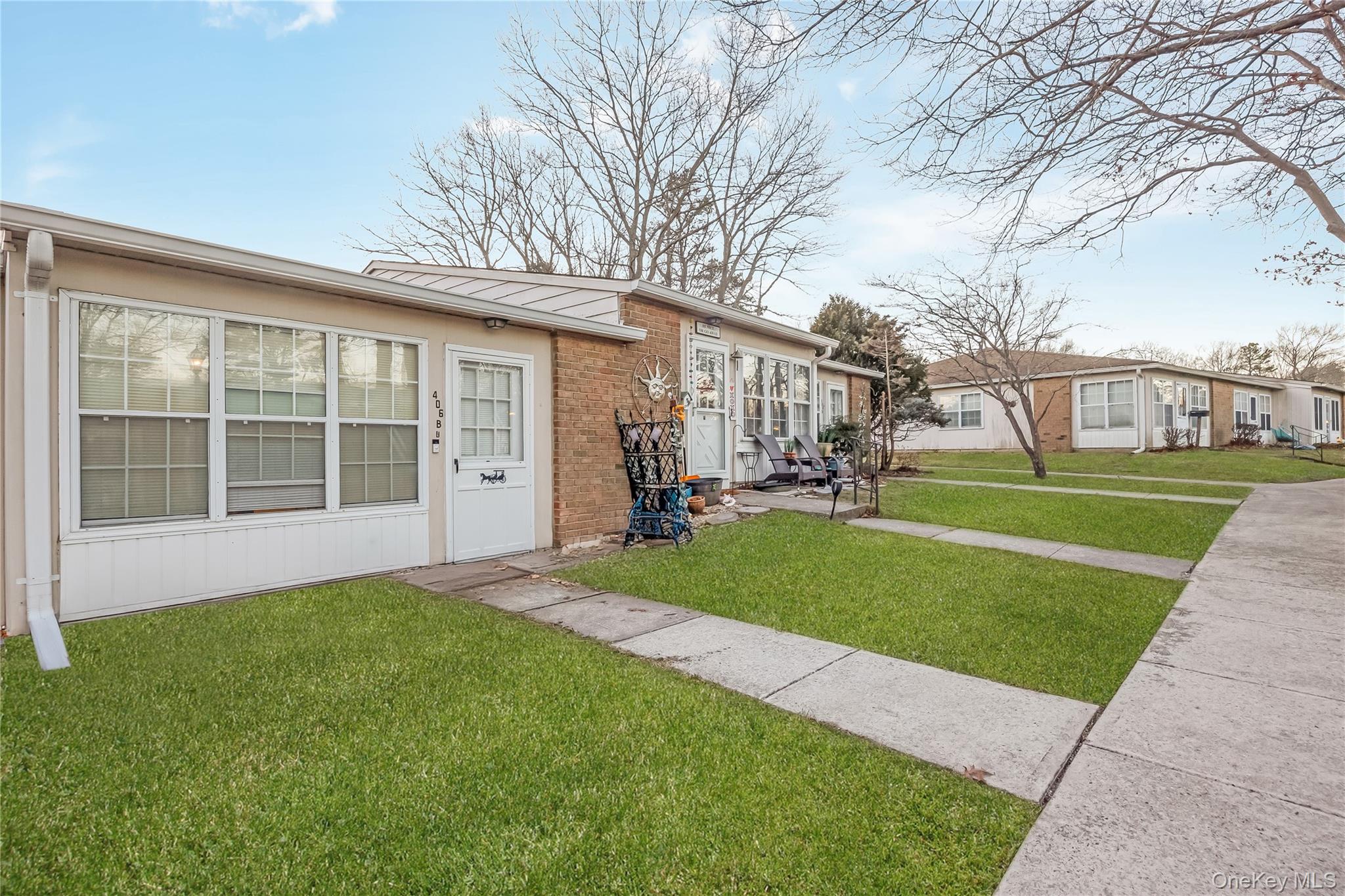 406 Woodbridge Drive, Unit B Ridge, NY 11961 - Photo 2 of 15 a view of a yard in front of house