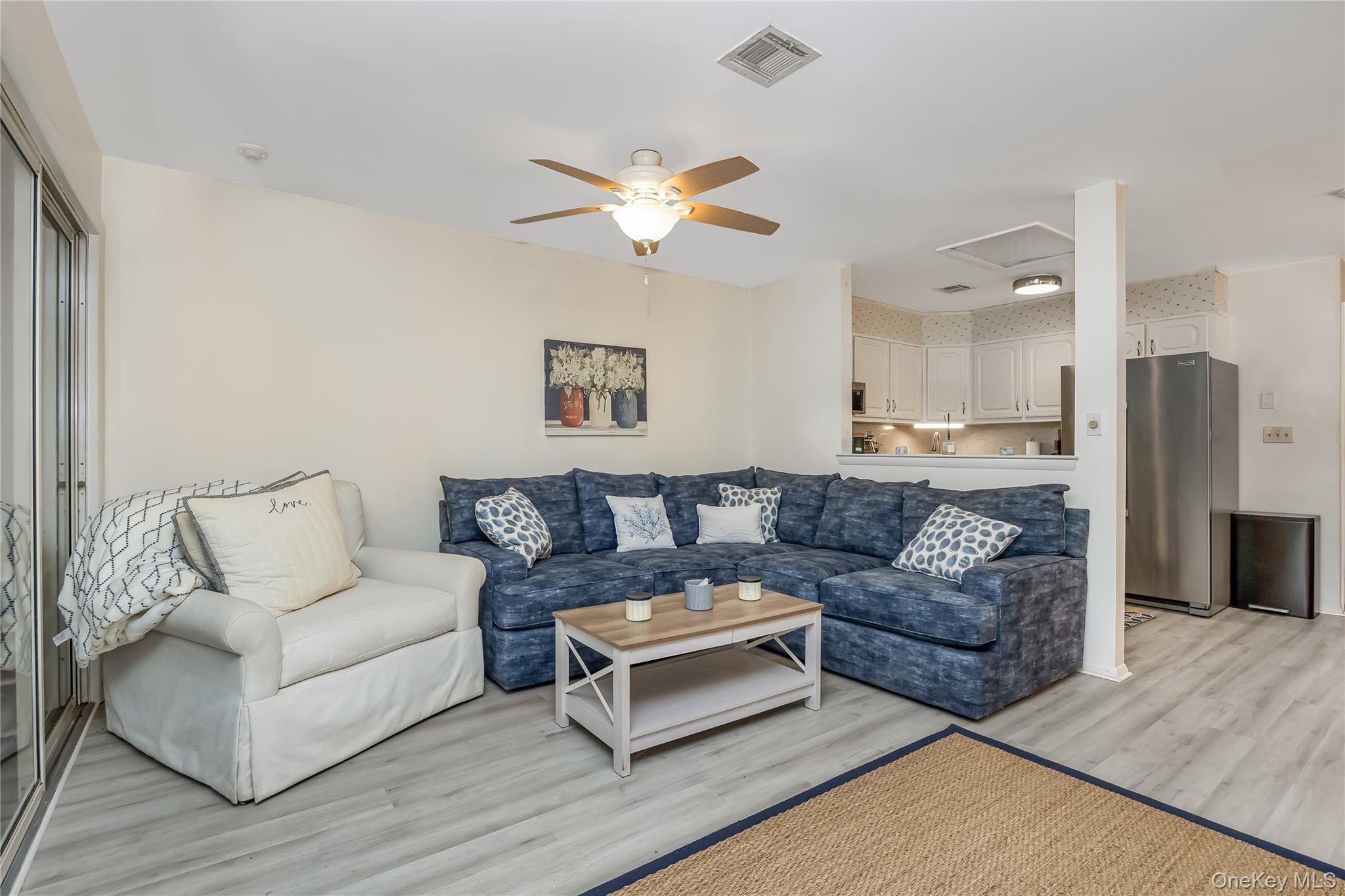 406 Woodbridge Drive, Unit B Ridge, NY 11961 - Photo 6 of 15 a living room with furniture and a fireplace