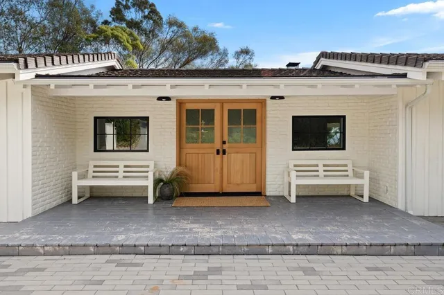 a view of a porch with a door and wooden fence