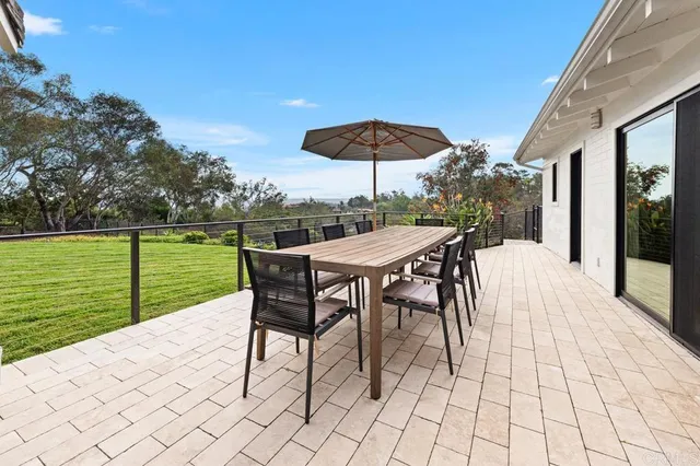 a view of a house with backyard sitting area and garden
