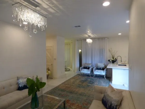 a lobby with furniture and a chandelier
