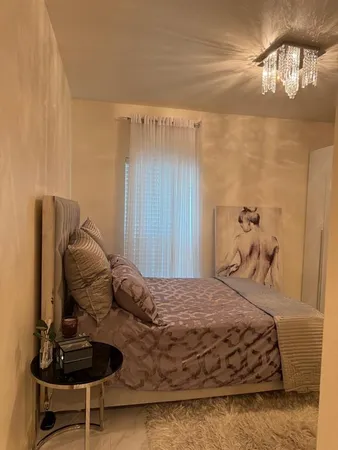 a bedroom with a bed and ceiling fan