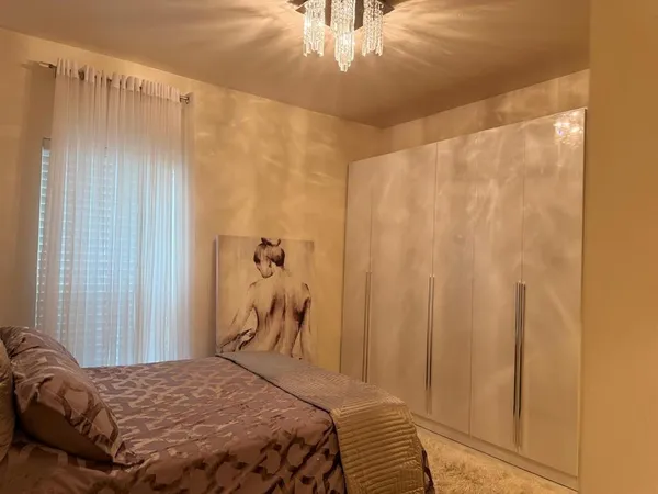 a bedroom with a bed and a curtain