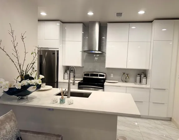 a kitchen with stainless steel appliances a sink stove and refrigerator