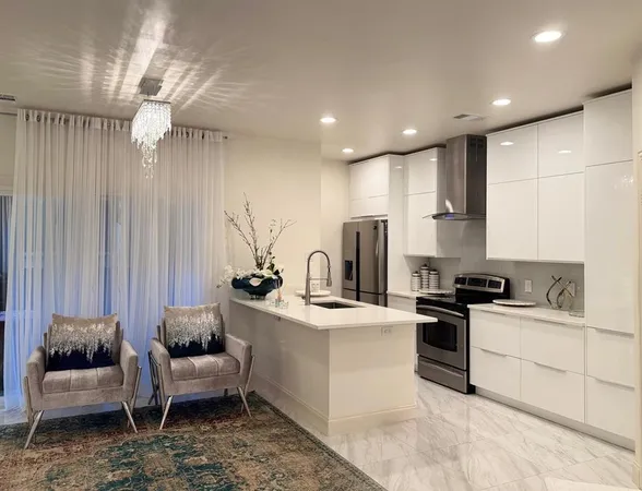 a kitchen with white cabinets and stainless steel appliances