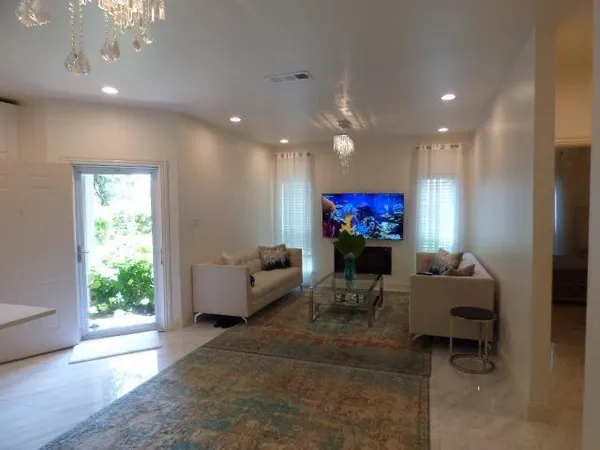 a living room with furniture and a flat screen tv