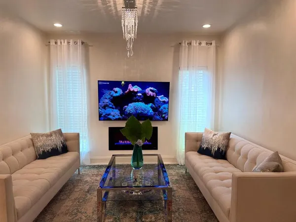 a living room with furniture a rug and a flat screen tv