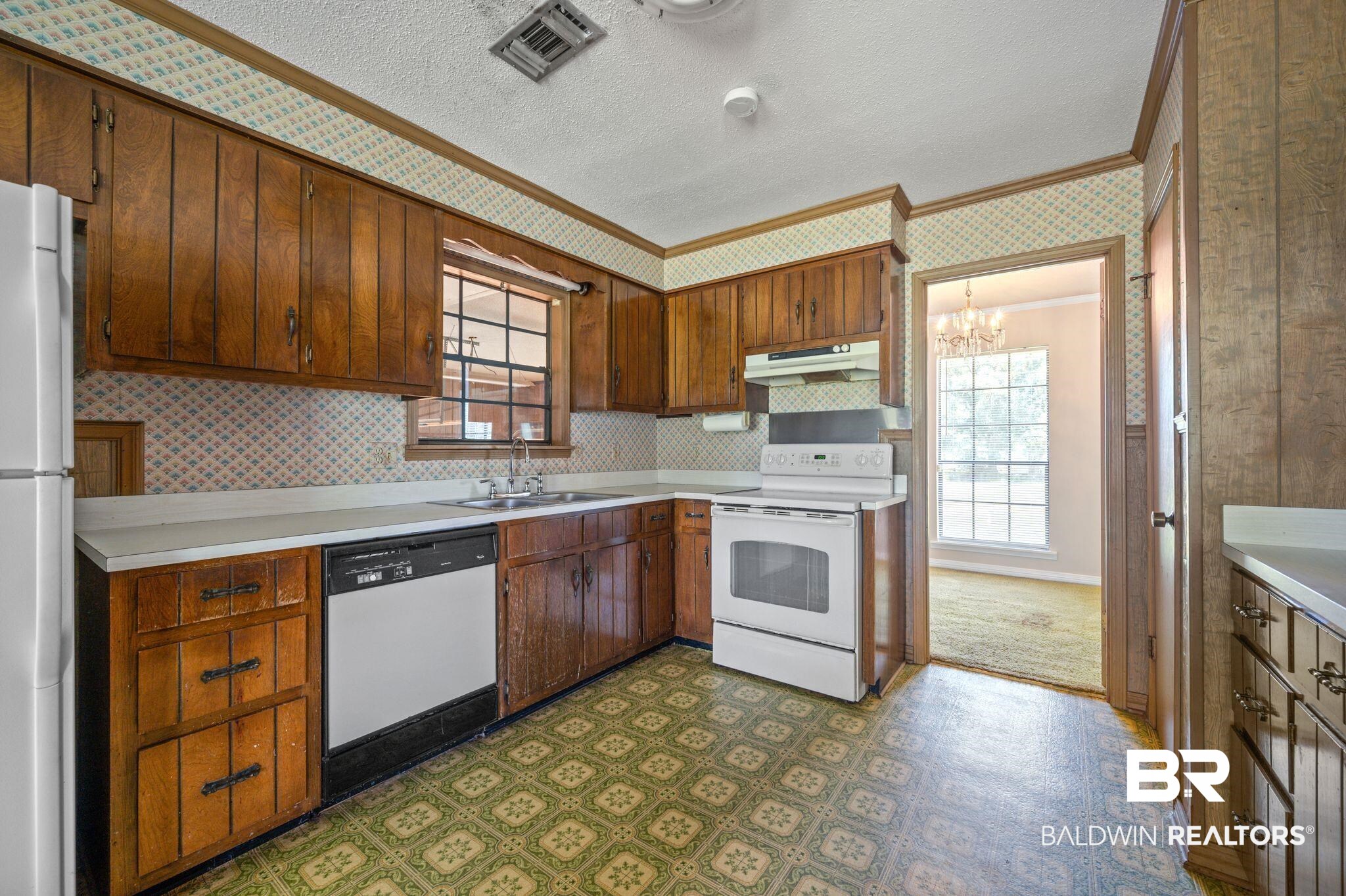 15880 Pine Grove Rd Extension West Bay Minette, AL 36507 - Photo 24 of 44 Kitchen featuring white appliances, an inviting chandelier, sink, dark carpet, and crown molding