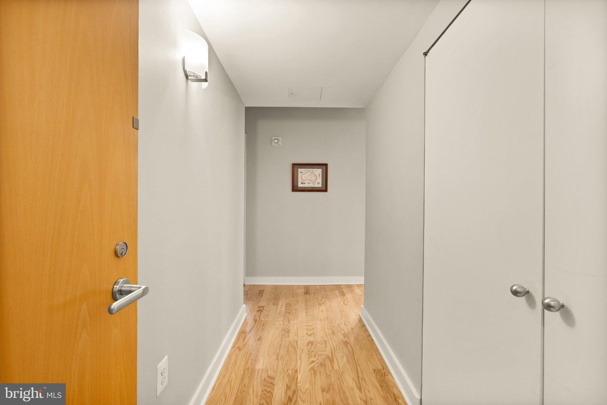 675 E Street Northwest, Unit 350 Washington, DC 20004 - Photo 9 of 29 Inviting hallway with warm wood floors.