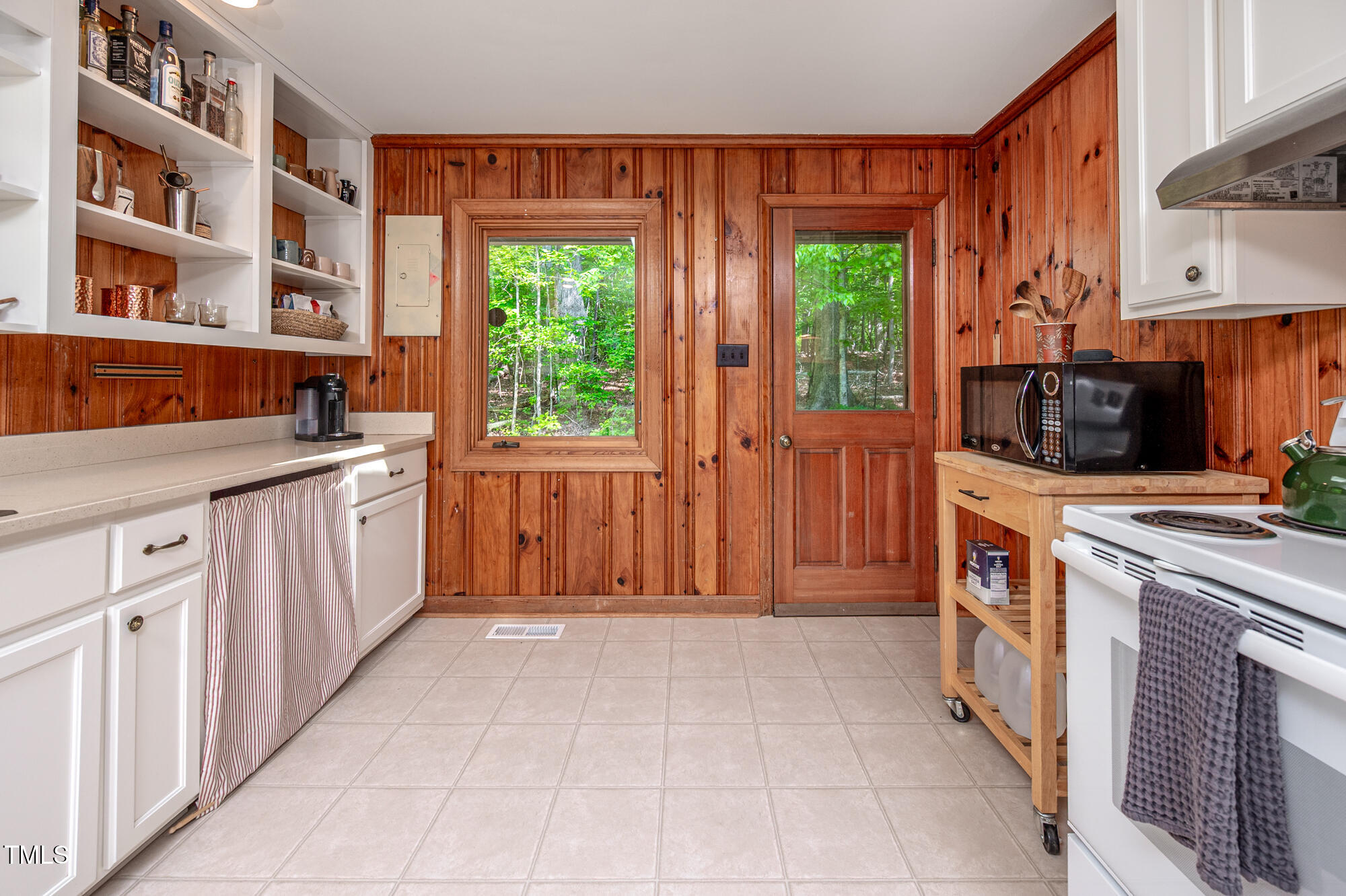 7723 Johnson Mill Road Bahama, NC 27503 - Photo 17 of 58 a kitchen with a stove top oven cabinets a sink and a window