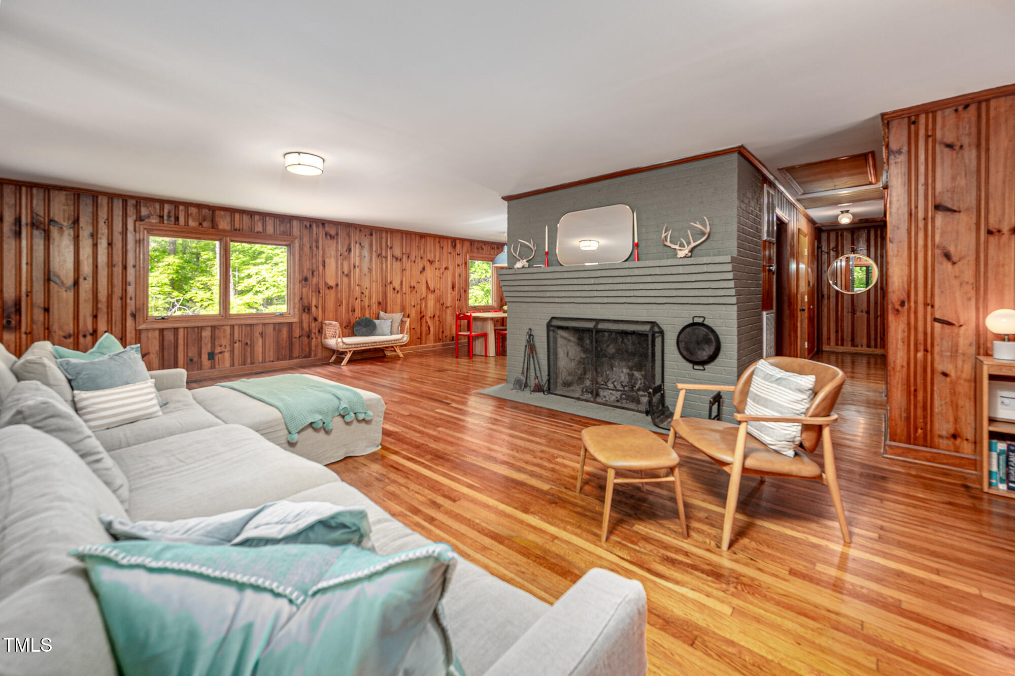 7723 Johnson Mill Road Bahama, NC 27503 - Photo 20 of 58 a living room with furniture a fireplace and a wooden floor